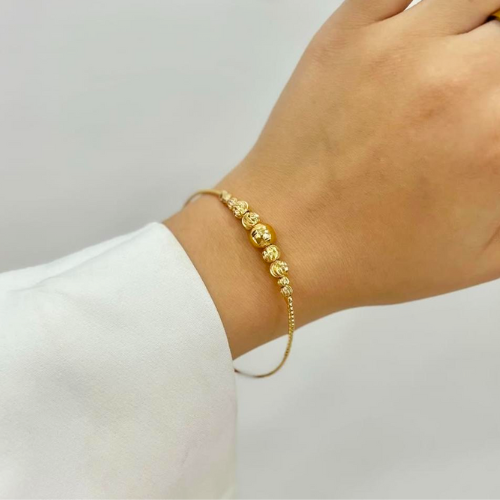 Manilla Dorada con Esferas Texturizadas – Elegancia Minimalista